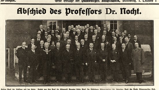 A photo of a newspaper article showing a large group standing on a staircase.