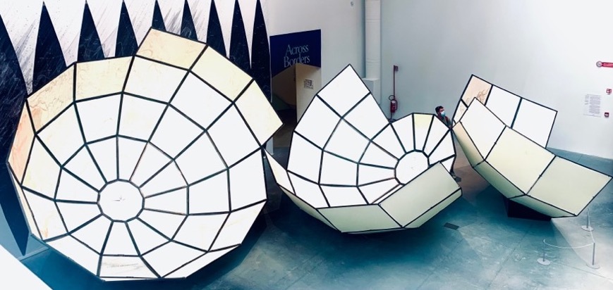 Image from an art installation at La Biennale di Venezia 2021. It shows bisected spheres of different sizes. Combined, they would form one sphere.