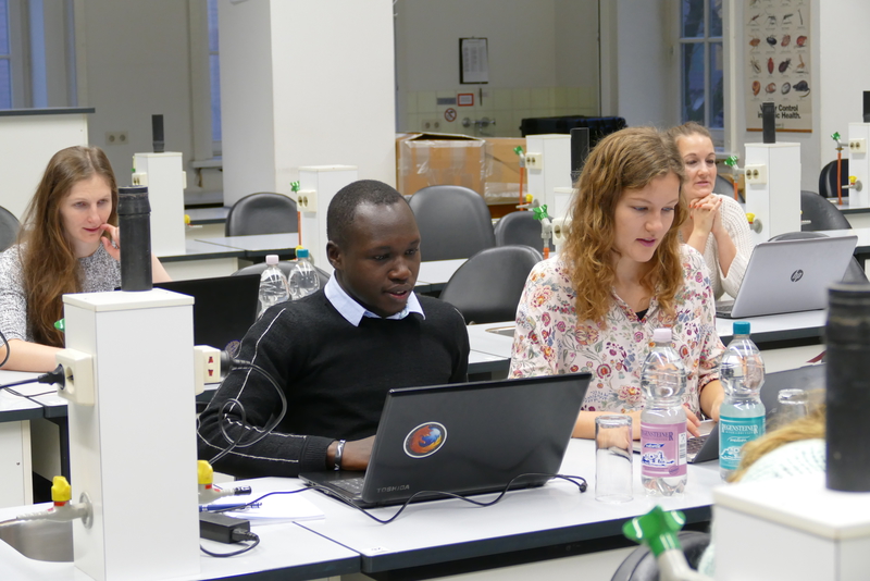 Eine Gruppe internationaler Studierender lösen Aufgaben an ihrem Laptop in einem Lernlabor.