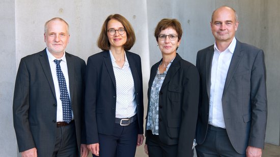 The Institute's management standing side by side in the new building