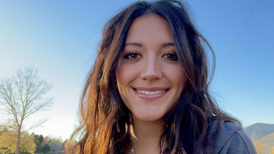 Kandace Baez Photo of doctoral student Kandace Baez. She stands in front of a blue sky, has long brown hair and looks friendly into the camera