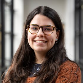 Young woman with glasses and long brown hair
