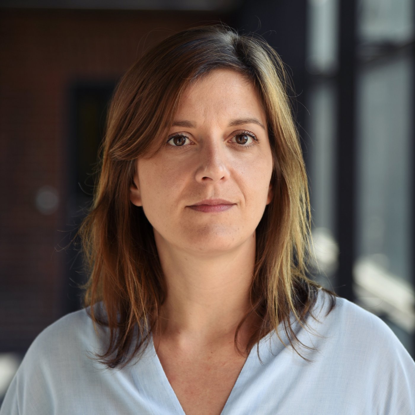 Dr Sophie Duraffour: a researcher with long brown hair and a light blue blouse.