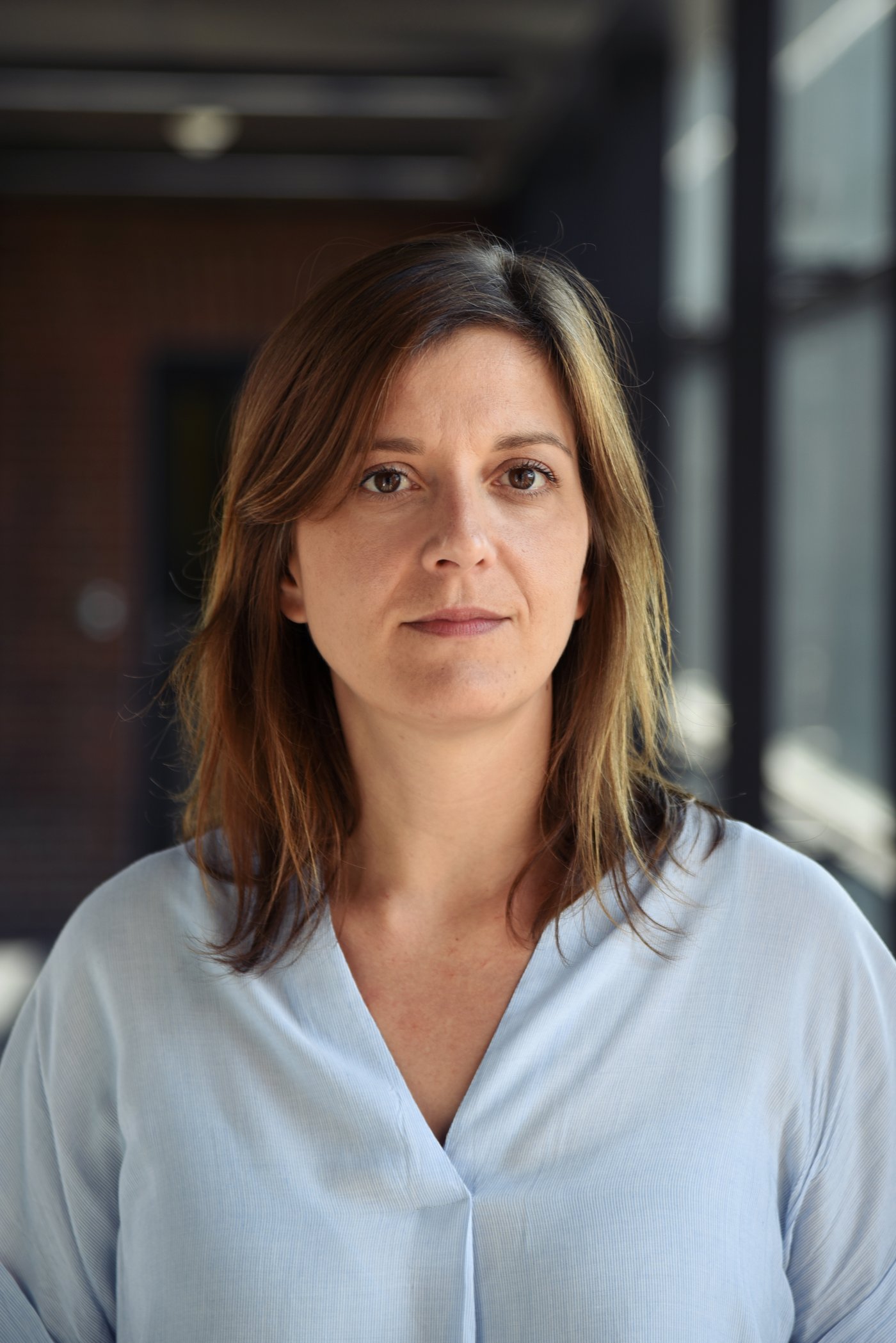 Dr Sophie Duraffour: a researcher with long brown hair and a light blue blouse.