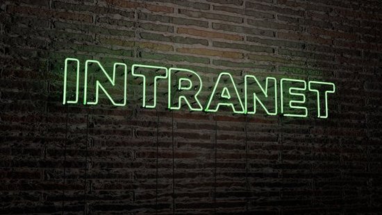 Intranet" with green glowing neon tube lettering in front of a brick wall.