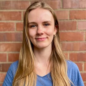 Selina Krüger Selina Krüger: A doctoral student smiles at the camera. She wears her long blond hair loose and a blue shirt.