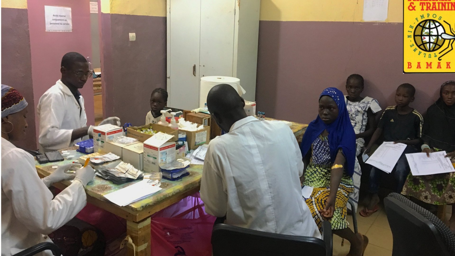 Malian scientists conducting routine clinical procedures during cross-sectional visits in Kalifabougou, Mali.