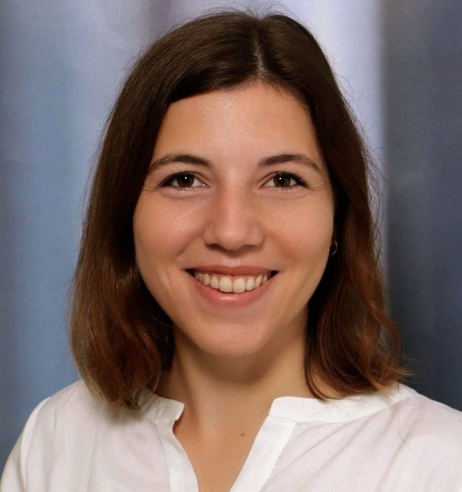 A smiling woman against a grey background