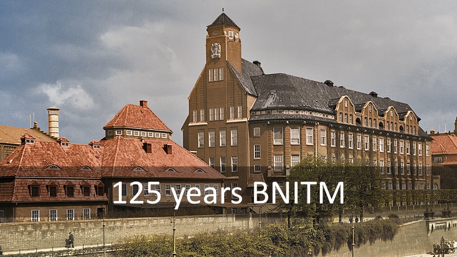 Historical building with striking architecture in front of a cloudy sky. Text: ‘125 years of BNITM’