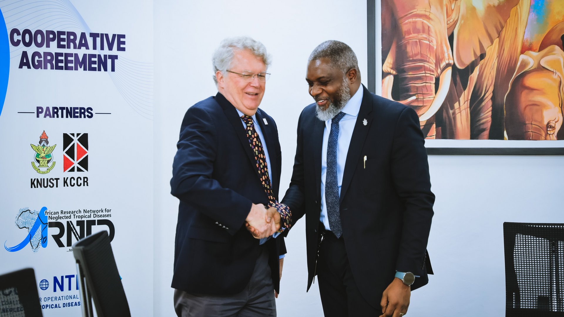Prof John Amuasi and Dr Pat Lami shaking hands