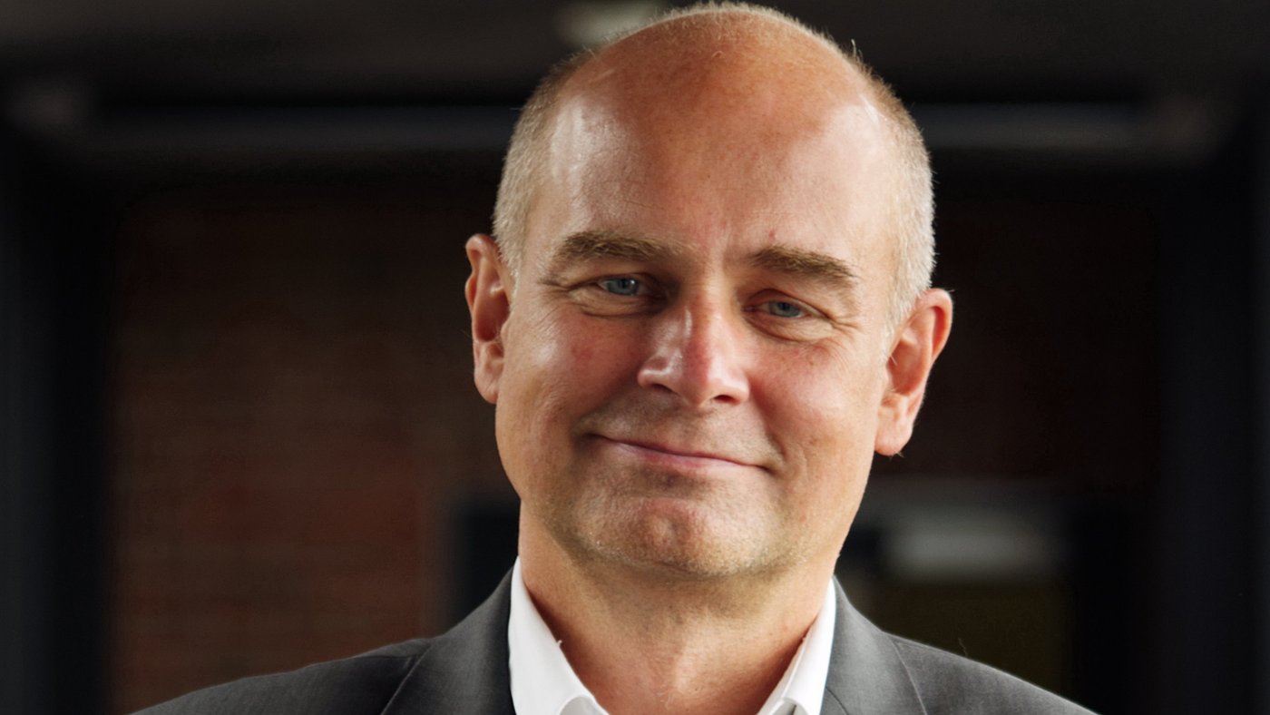 Prof. Dr Jürgen May:a researcher who is bald and wears a white shirt with a gray jacket.