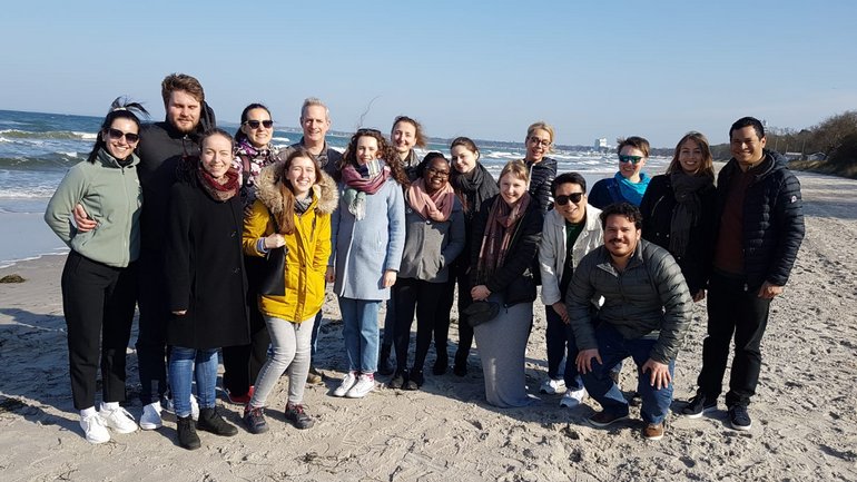 Group of people at the beach in jackets