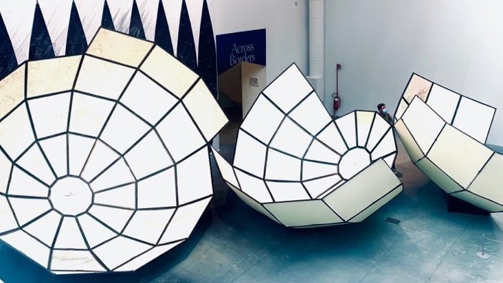 Image from an art installation at La Biennale di Venezia 2021. It shows bisected spheres of different sizes. Combined, they would form one sphere.