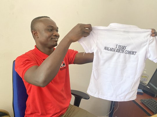 MBC study coordinator Felix Osei Boateng showing us the back of the T-Shirt