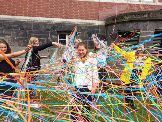 Marie Groneberg, the institute's newly crowned prizewinner, is seen here in the garden with her colleagues, as she is showered with streamers..