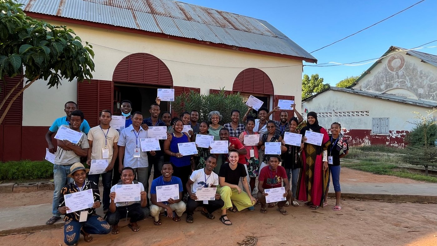 Participants of capacity strengthening program in Madagascar in front of a builduing with their certificates in the hands