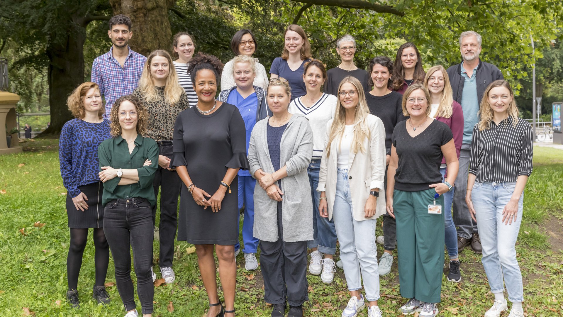 Diverse group of researchers standing on a grassland