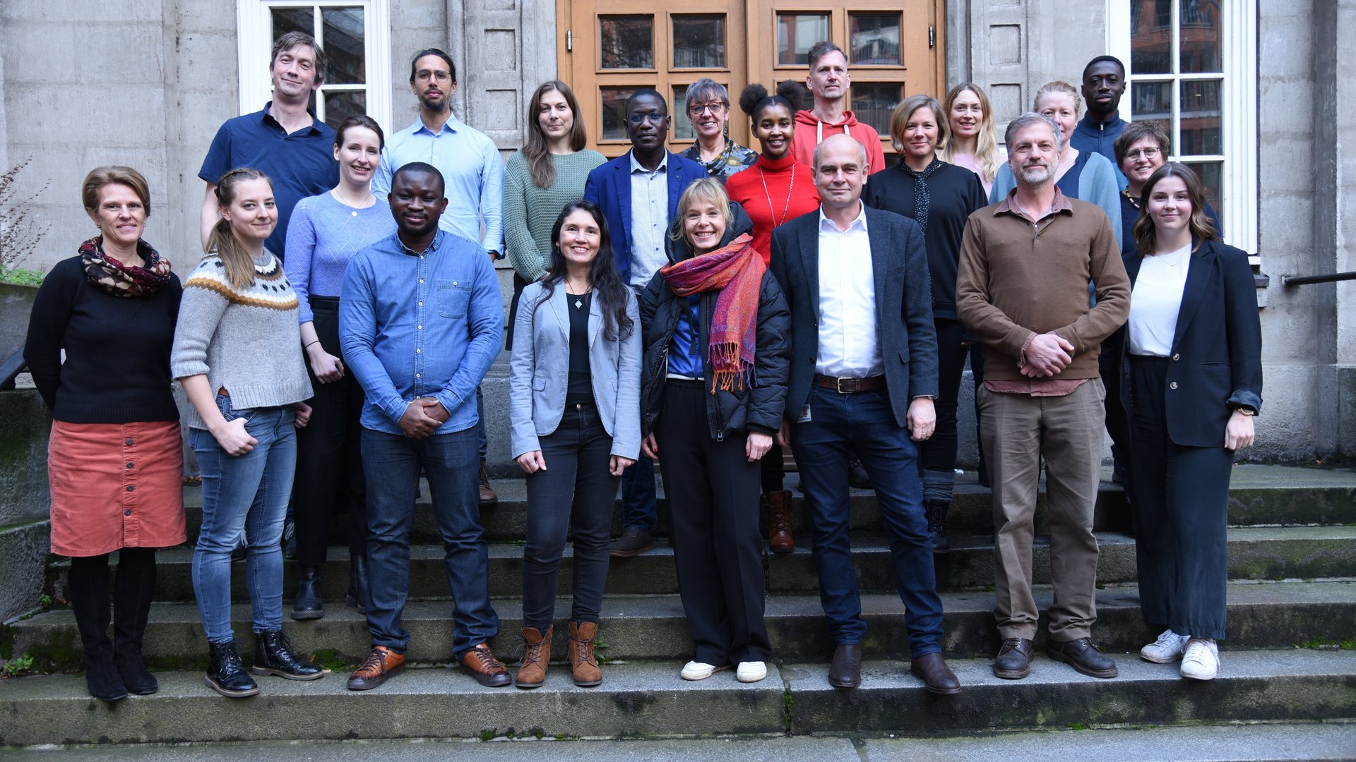 Group of researchers standing in front of a building