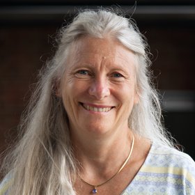 PhD Elisabeth Fichet-Calvet: a researcher with long, white-blond hair and a casual T-shirt.