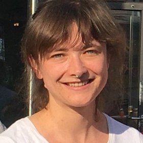 Dr. Lara Linnemann Dr. Lara Linnemann: eine Forscherin, die ein weißes Oberteil, und kurze, braune Haare mit einem Pony trägt.