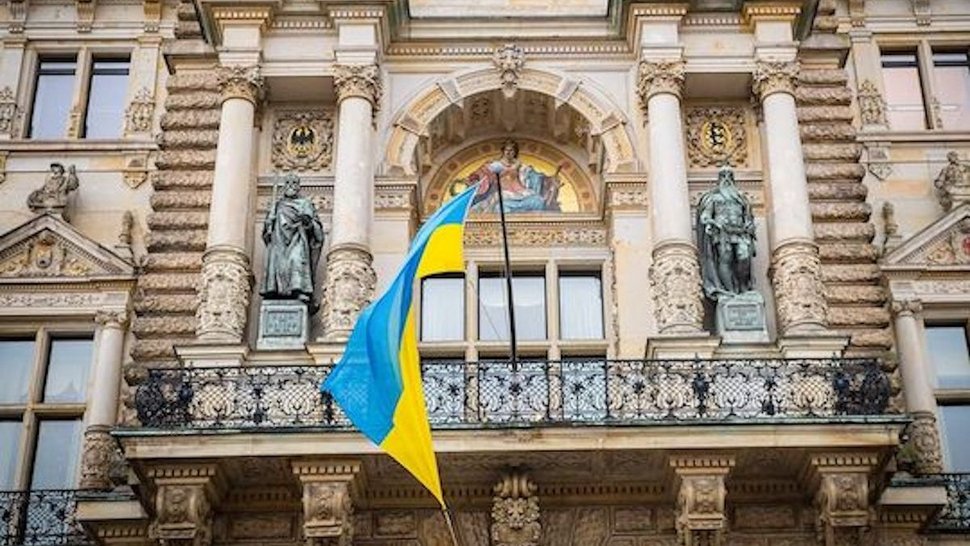 [Translate to English:] Zu sehen ist das Hamburger Rathaus mit der ukrainischen Flagge