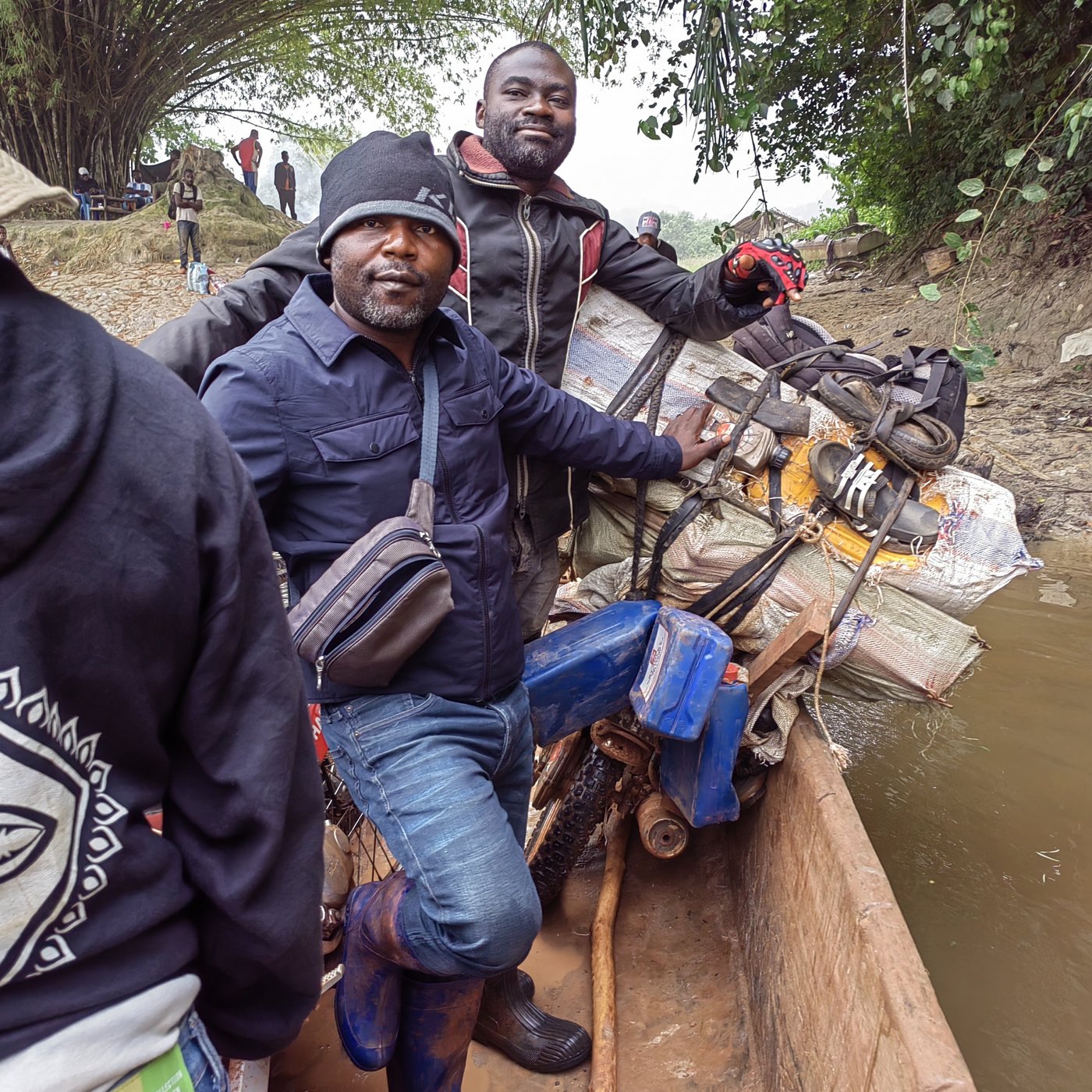 Two men crossing a river in a boat