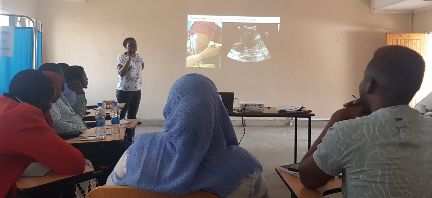 The picture shows a lecturer holding a presentation on ultrasound.