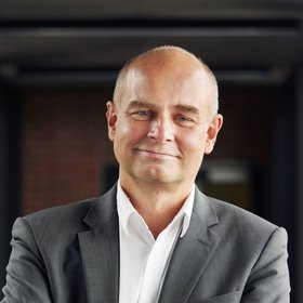 Portrait photo of Prof. Dr Jürgen May: an experienced researcher who is looking friendly towards the camera