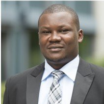 Alex Olengo Alex Olengo, a man in formal attire, including a suit and tie, is depicted as a researcher, exuding professionalism and intellect.