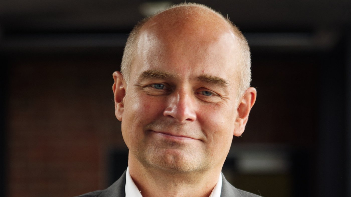 Prof. Dr Jürgen May:a researcher who is bald and wears a white shirt with a gray jacket.