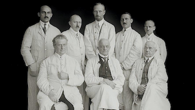 The picture shows a black and white photograph of former BNITM doctors.